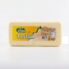 Packaged cheese block in a clear plastic wrapper with a bright yellow label reading 'Tostluk' on a white background, 700 g e