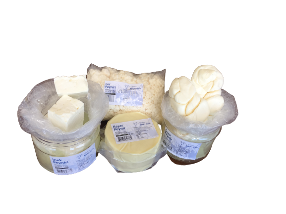 Assorted dairy products on a black background: blocks of butter, shredded cheese, a jar of soft cheese, and a topped container wrapped in plastic.