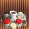 Assorted takeaway coffee cups with plastic lids arranged on a wooden surface against a slatted wooden wall.