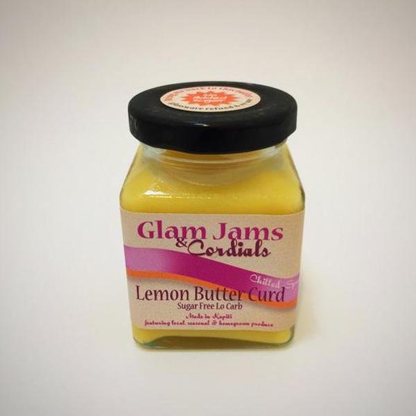 Lemon butter curd in a small glass jar with black lid; label reads 'Glam Jams & Cordials'.